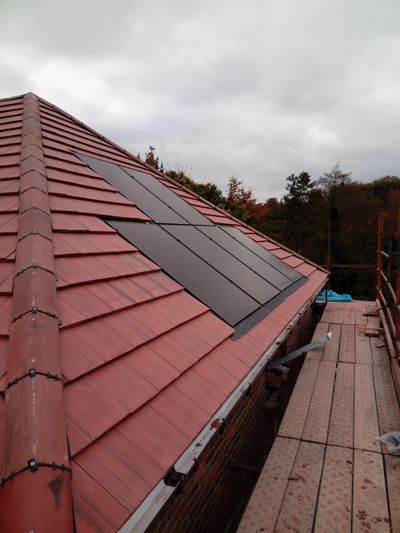 Solar panels installed on a red tile roof