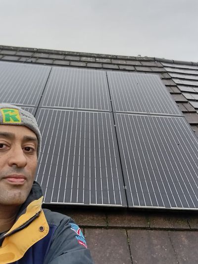 Ashley Merritt wearing safety equipment while installing solar panels