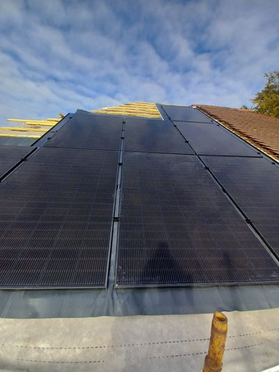 Solar panel installation work in progress on roof