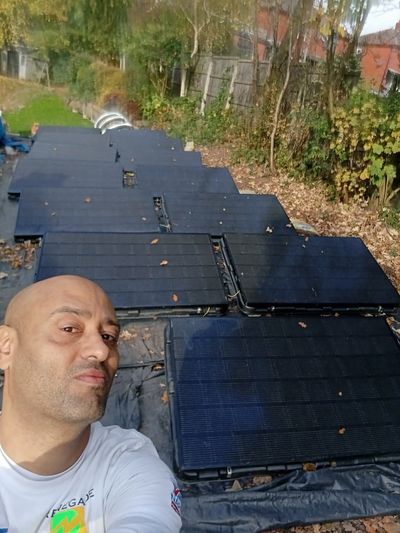 Ashley preparing solar panels on the ground before installation